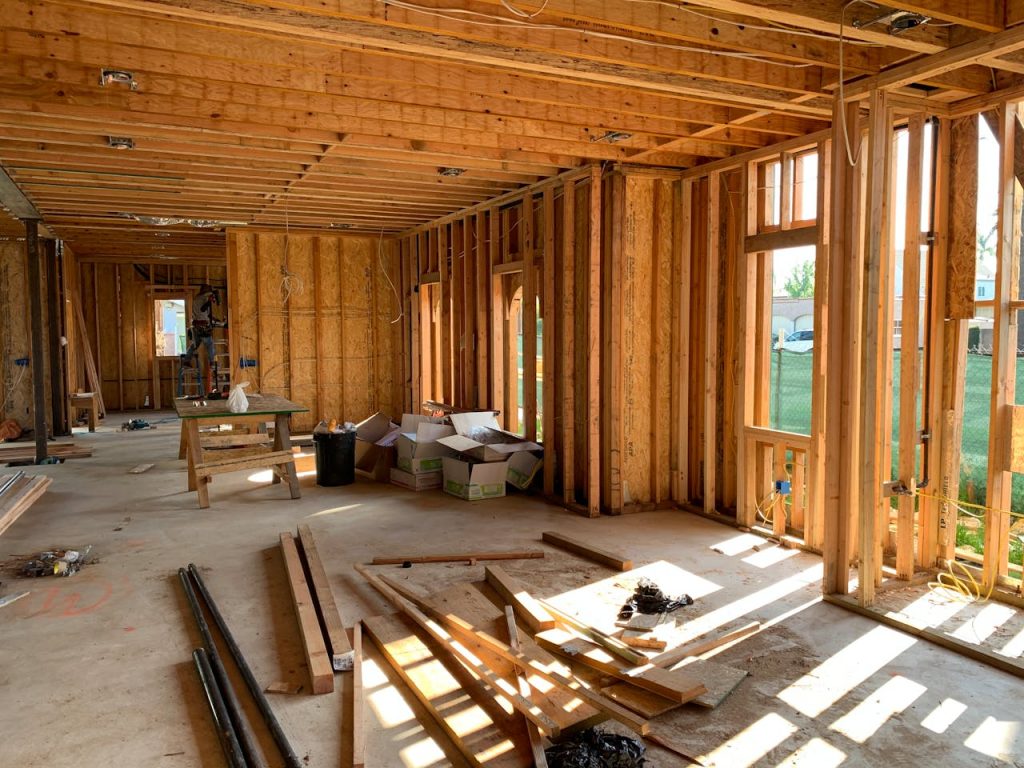 pexels-photo-4642438 Sunlit interior with wood framing, showcasing home construction progress.